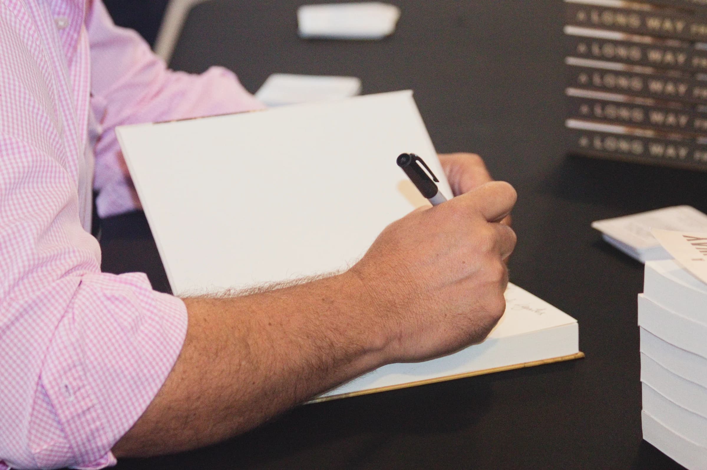 A dedication being written during a book signing