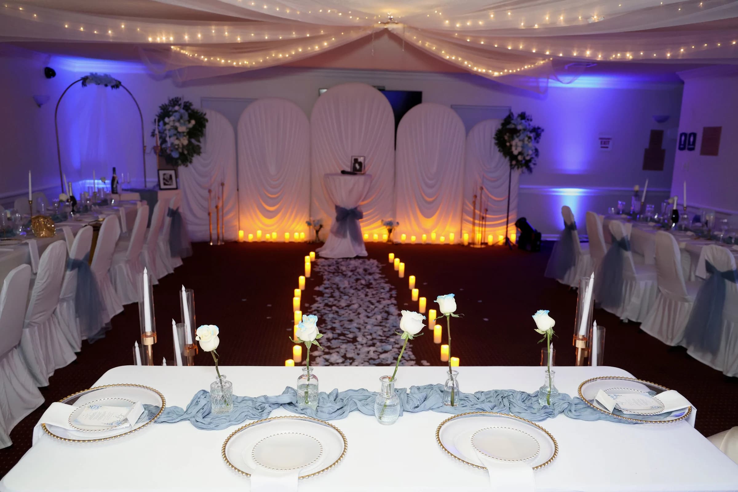 Reception tables with white flowers and candles